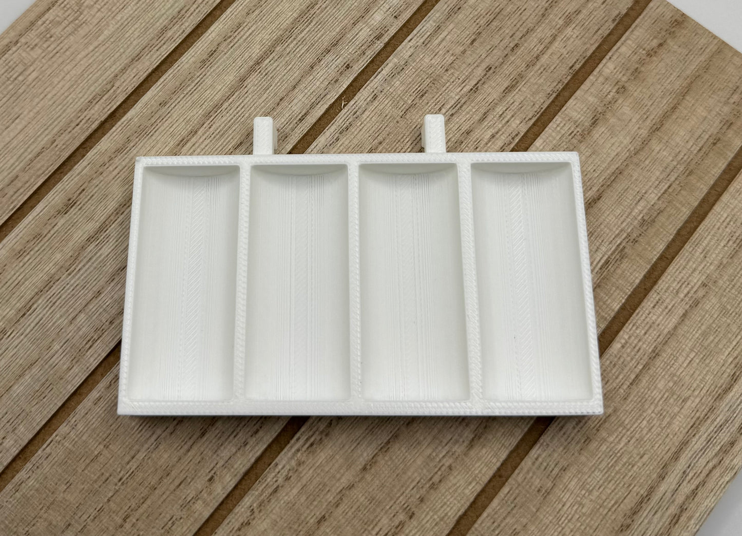 An empty Skadis Bobbin holder in white